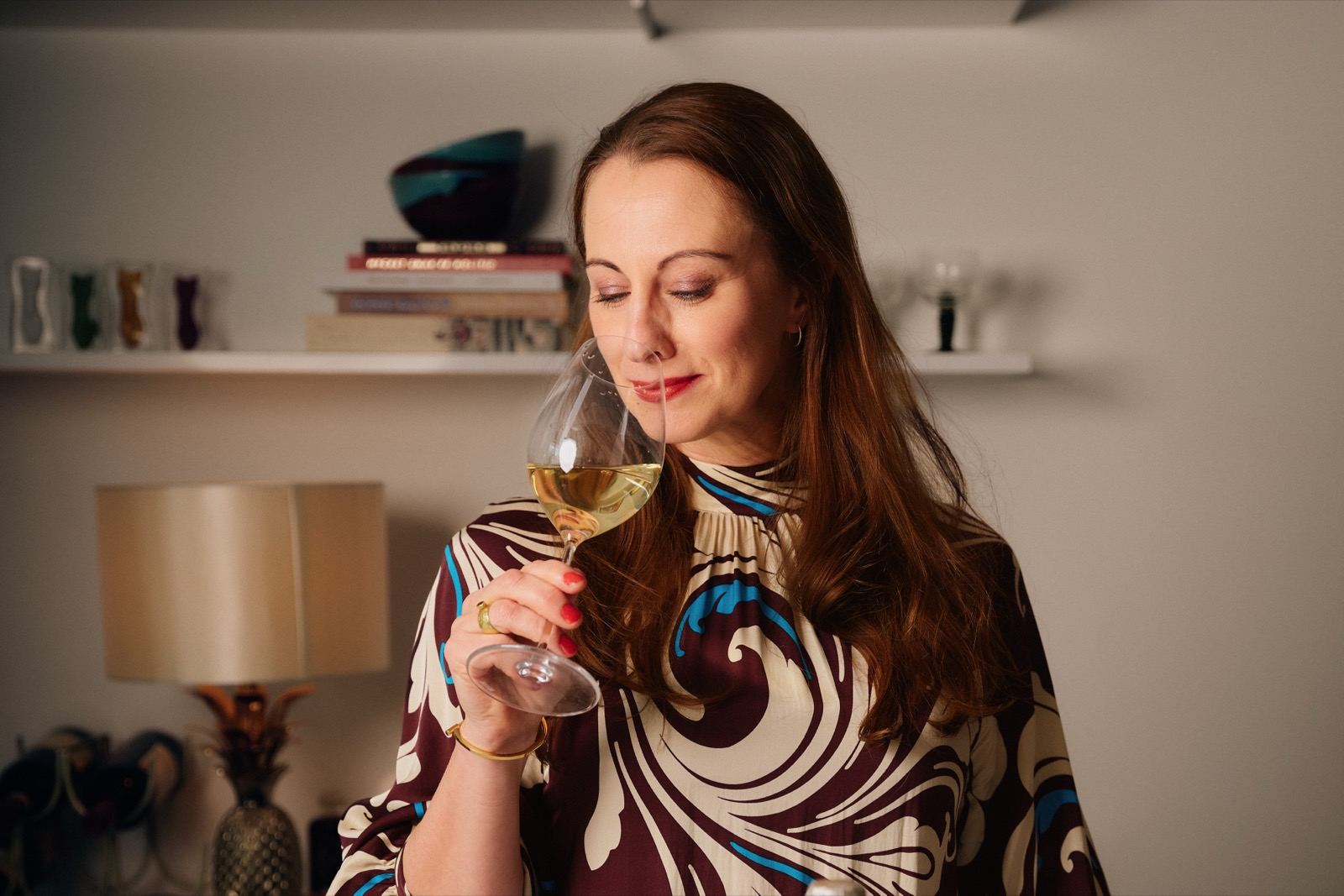 Camilla Sand smells wine in the glass